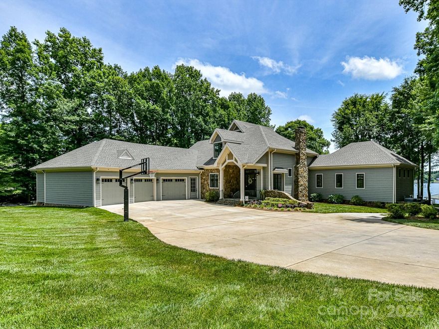 Beautifully updated, custom home w/ private beach, & ~150 ft of shoreline on Lake Wylie w/ views from every room! Kitchen boasts Thermador induction stovetop, built-in Frigidaire refrigerator/freezer, & massive island w/ additional storage. Living room features a stone, wood-burning fireplace, built-in bar & sets of French doors leading to the covered patio. Primary bedroom on main w/ large ensuite bath & walk-in closet, & access to rear patio. Large laundry room w/ home office built-in desk space & utility sink. Additional guest bedroom w/ ensuite bath, drop zone, & powder bath complete the main level. Upstairs features 2 additional guest bedrooms, both w/ ensuite baths, as well as spacious bonus room w/ built-in wet bar. 3rd floor flex space is great for home office, man cave, kids play space, w/ balcony overlooking the backyard & lake. Multiple paths to the water, w/ sandy beach, gazebo, fire-pit, picnic area, and floating dock with boat slip. A property made for entertaining!
