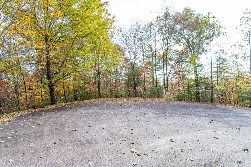 Situated within the desirable Mountain Brook community, this 2.17-acre wooded lot offers the perfect setting for your mountain retreat. Located on a quiet, paved, privately maintained road, the property sits between 2,500–3,000 feet in elevation and provides a peaceful, natural backdrop surrounded by mature hardwoods. With a minimum build requirement of 1,600 square feet, the neighborhood maintains a sense of quality and harmony while allowing design flexibility. A septic permit application is currently pending.  Lot offers mountain views.  Conveniently located just minutes from downtown Brevard, residents of Mountain Brook enjoy proximity to the French Broad River, Pisgah National Forest, and an abundance of outdoor recreation opportunities—making this homesite an ideal balance of privacy and accessibility in Transylvania County.
