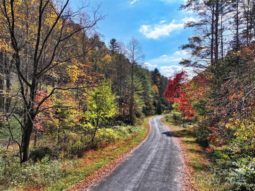 18.54 +/- acres of prime UNRESTRICTED land, perfect for a homestead, hunting retreat or second home/short term rental, with room for multiple homes!  OWNER FINANCE IS AVAILABLE for qualified buyers!  Be the king or queen of your very own mountain -- watch the drone video and marvel at the epic views!  https://www.youtube.com/watch?v=EjqWTI8f2bs  This ideal location is just a few minutes from iconic Griffith's Country Store -- get your gardening supplies and advice, and chat with your neighbors! The Toe River is only 5 minutes away for your fishing or floating adventures.  Yet this gem is tucked into a quiet location on a dead end road off another dead end road, giving the owner idyllic privacy and serenity.  The parcel has some gorgeous old hardwoods, with lots of maple trees for peak autumn foliage right on your own property! This old homestead site is being brought back to life, with the clearing having revealed a spring-fed water source, UTV trails through woods that are rich with wildlife, and cleared flatter land at the bottom of the parcel alongside the creek and public paved road.  The property already has electric on site and there are multiple nice potential homesites tucked into the trees.  Plan your garden now and watch it grow like topsy while you build your dream home!  Although you will feel worlds away on this private parcel, Burnsville and Bakersville are only 20 min away for groceries, restaurants, shopping and the arts, while Asheville NC and Johnson City TN are about an hour away.