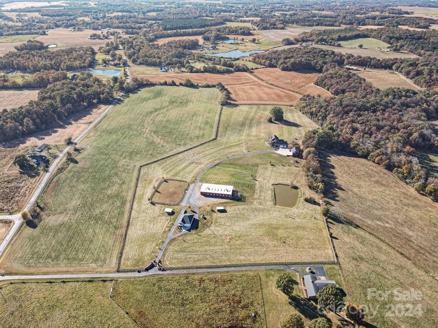 Welcome to Vista Breeze, an Equestrian estate featuring multi generational living & all the best that country life has to offer close to the city. 4202 HLA main home has 4 bdrs/3.5ba & 2 bonus rooms. Primary bdr on the main w/ luxurious bath, his/her vanities & walk in closets. Granite kitchen w/ tons of extras. Sunroom. Separate 3 car detached garage has 916 HLA apartment above. Chair lift installed for apartment access. 1621 HLA 3 bdr/2ba 2018 ranch home (2410 Faulks Church Rd PID 02-254-012-A). Barn has 10 horse stalls with room for an additional 6 stalls, equipment storage, office space and bathroom. Property has riding ring, 2 run in shelters & 3 large fenced pastures. Total acreage is 29.25 acres. Pond has been stocked in the past with cat fish & bass for fishing & recreation. Small boat on pond coveys w/ the property. 25 acres of the property is fenced w/ a remote gate at the front. Both properties must be sold together. Quick access to uptown Charlotte via the Bypass.