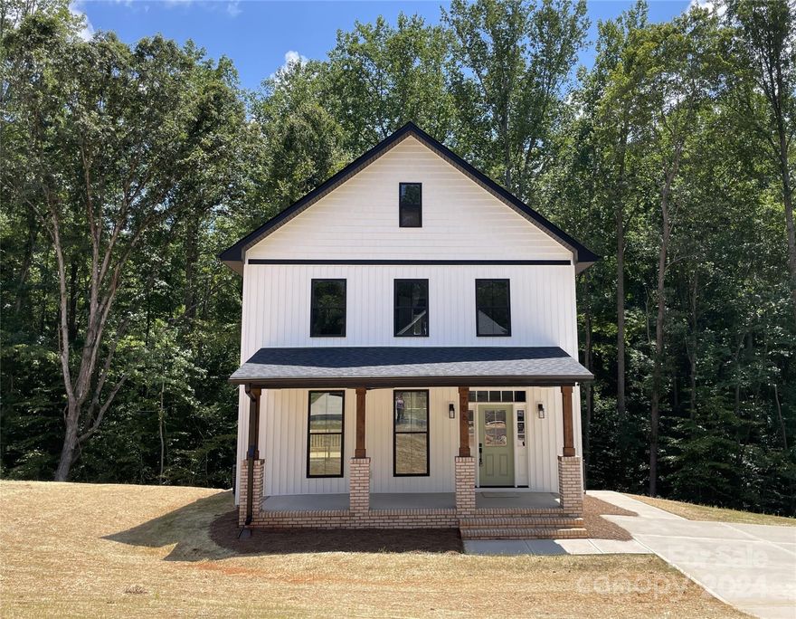 UNDER CONSTRUCTION 2-story expanded Mahoney plan on premium 1.3872 acre lot bordering a creek and wooded view. Target completion date 8/31/2024. Hurry to make interior choices per available list of options and allowances. Will have upgraded black windows and white vertical siding. At time of listing, you could still choose kitchen cabinet color and granite for kitchen and bathroom vanities, tile for shower surround, light fixtures, kitchen backsplash, appliances, incl fridge, luxury vinyl plank in living areas and baths, carpet color in BRs, and 1 color paint choice throughout (optional upgrade to a different color per room). Primary BR has walk-in closet and bath with step-in shwr, tiled  surround, glass door. Approx 16'x16' deck. Architectural roof. Efficient all electric with heat pump. New plan, so no representative pics available. Floor plan and front drawing do not reflect expanded 28x28 foundation and enlarged 8x24 covered front porch. Road will be paved & city-maintained.