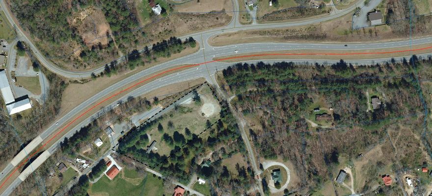 Prime 3+/- acre level unrestricted site with visibility from Highway 64/Rosman Hwy. Water, sewer and gas utilities available and accessibility from 2 streets.