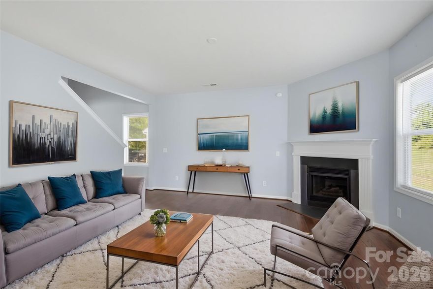 This home offers a sophisticated blend of comfort and style in the desirable Applegate community of Charlotte. Thoughtfully designed and beautifully maintained from the moment you step inside, you’re welcomed by rich hardwood floors that sweep through the main level, setting a warm yet refined tone. The living room is anchored by a beautiful fireplace, offering a serene space for quiet evenings. The kitchen is both stylish and functional with generous cabinetry, granite countertops and right next to the patio door for easy outdoor grilling access.  
Upstairs, the primary suite offers a wonderful large bathroom complete with a double vanity and a soaking tub ideal for unwinding. The additional bedrooms provide versatility and comfort, whether used for guests, family, or a dedicated home office. Outside, the backyard offers privacy and a spot for entertaining