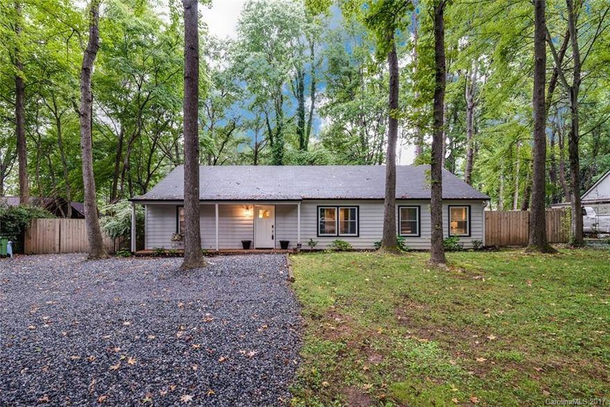 Pristine RANCH on private wooded lot in CORNELIUS!! Beautiful screened in porch AND separate Hot Tub screened in room! Character throughout! New bamboo floors! Fresh paint! Newer roof, windows, and HVAC unit. Granite counter tops, updated baths. Huge great room open to DR & kitchen. Extra room in oversized driveway for an RV and 3-4 cars! Owner also installed electric & sewer hook ups beside home for RV. NO HOA! Walking distance to the park, Antiquity shops / downtown Davidson.