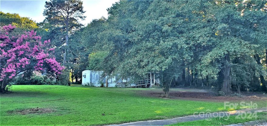 GREAT INVESTMENT OPPORTUNITY! Beautiful Level Lot with Stately Trees in Desirable Clover Location! Only a Few Blocks to Downtown Clover & 1.2miles to Wonderful "New Centre Park" on 50 acres that Includes 4 Lighted Soccer Fields, Amphitheater, Disk Golf Course, Splash Pad,Playgrounds & Concessions w/Restrooms ~ This Property is Over 1/2 acre with Beautiful Treed Border ~ Zoned R7 Which Allows for Duplex/Triplex/Quadraplex/Manufactured homes with Zoning Approval ~ Tree Lined Street with Sidewalks and Close Proximity to Charming Downtown Clover with its Great Homestyle Restaurants and Shops ! Wonderful Opportunity To Build Your Own Home in Award Winning Clover Schools ! Manufactured Home on Site Will More Than Likely Need To Be Removed But Could Absolutely be Renovated for the Savvy Consumer! Easy Access to Hwy 321/85~ Crowder’s Mountain Nearby! No trespassing on property without an appointment. Sold as-is where is with all contents.