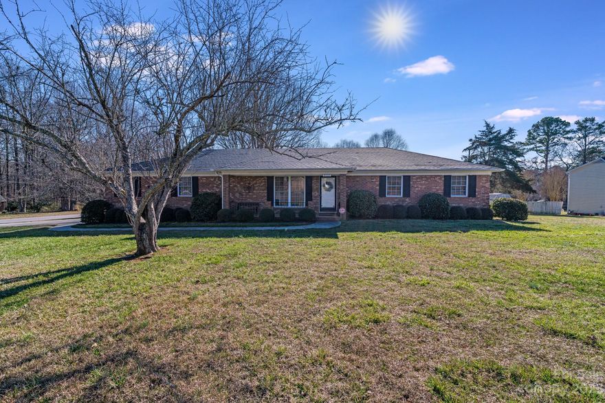 Don't miss this 3BR / 2 Bath all brick ranch that is on a corner lot that is over a half of an acre. It checks many of the desired boxes right there. But it doesn't stop there. Coming in the front door, you you step into a large great room as you enter the home. From there, you are lead into the spacious living area which features a gas fireplace and lots of room. Go down the hall to the large carpeted bedrooms. The bathrooms feature some upgrades to suite your taste. The kitchen features a large open space with lots of cabinets and counters but still with room for dining. It also has a built-in closet with your easy to get to washer/dryer. The back door leads you out to a patio area that has a privacy fence around it. This roof on this lovely house was replaced in 2018. The garage is an oversized space with a workshop area built-in. In your new home, you are just a mile from downtown Mint Hill for all of your shopping and dining needs and a mile from I-485 made for easy commuting.