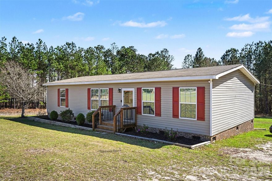 This charming, move-in ready home is ready to welcome its next owner! Situated on a large, tree-lined lot with no HOA, this 3-bedroom, 2-bath home features a split floor plan with the primary suite thoughtfully separated from the secondary bedrooms for added privacy, along with a bright, open layout perfect for everyday living and entertaining.

Freshly painted with Sherwin-Williams paint and updated with new carpet, the interior feels clean and refreshed throughout. The spacious kitchen is a standout, complete with a large island, plenty of room to gather, and includes the refrigerator. This home has been well maintained, is smoke-free, and has been professionally cleaned for its next owner.

The primary suite provides a comfortable retreat with its own private bathroom featuring dual sinks and a large walk-in closet you’ll absolutely love.

Step outside onto the freshly stained deck—ideal for relaxing after a long day or hosting family and friends. Surrounded by mature trees for added privacy, the property also includes two storage sheds and a custom-built hobby shed that is wired, equipped with a window A/C unit, and ready to be connected to power—perfect for projects, a workshop, or additional flex space.

Enjoy the best of country living with the convenience of groceries, dining, and shopping just minutes from home.

Additional updates include a newer HVAC condenser and water heater, both replaced approximately 2 years ago. With great neighbors and a peaceful setting, this is the perfect place to call home. Schedule your tour today!