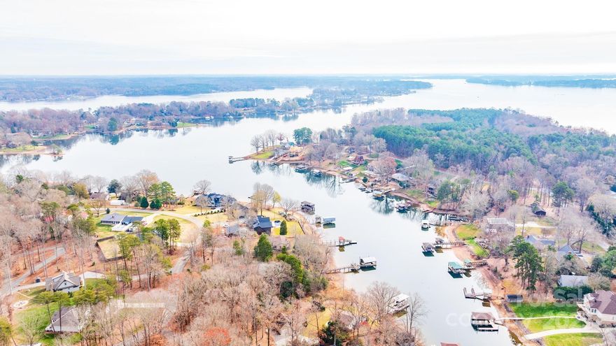 Lake Norman Waterfront Lot in the very desirable Sherrills Ford area. Unrestricted lot with no HOA.  Build what you desire. This lot is in a great location within 2 mins of the New Publix Market and other shopping/restaurant needs. Nice, gently sloping lot for a basement home. Very Rare On Norman!  111.3 ft. of shoreline. Must see this lot in person. The new owner may apply for a Dock permit through Duke Services. The dock was destroyed in a storm and never rebuilt. The location of the original dock is indicated by the red metal anchors. Well installed, but will need more due diligence from the buyer.  A two-bedroom, partially finished basement home has been removed from the property. No septic permit on file with the county. Contact Realtor to view the property.  Make an appointment through ShowingTime.