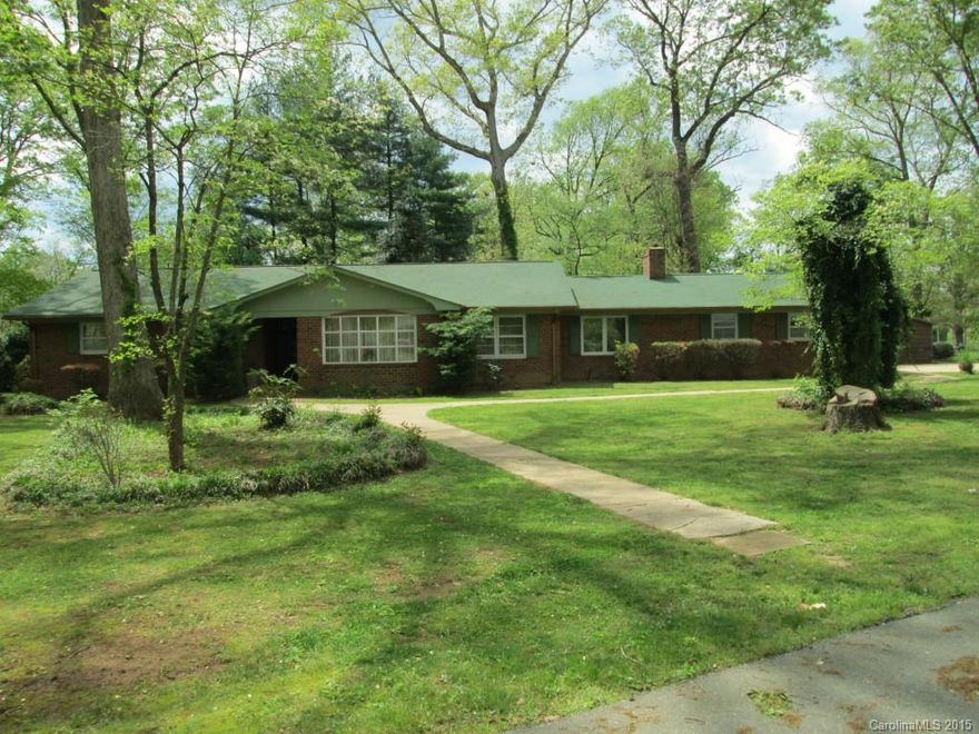 GREAT BUY! LOOK AT SQUARE FOOTAGE IN FULL BRICK RANCH IN POPULAR CELESTE HENKEL & WEST IREDELL SCHOOL DISTRICTS.Slate foyer to formal LR w/French doors&wood floors opens to nice-sized formal DR w/wood floors& French doors to kitchen.Spacious kitchen w/good cabinet storage,lots of countertop space&breakfast rm.Den offers masonry FP.Big screened porch w/adjacent patio-both have good condition broken tile floors.Utility rm serves as small workshop plus ample double garage&2 separate storage bldgs.