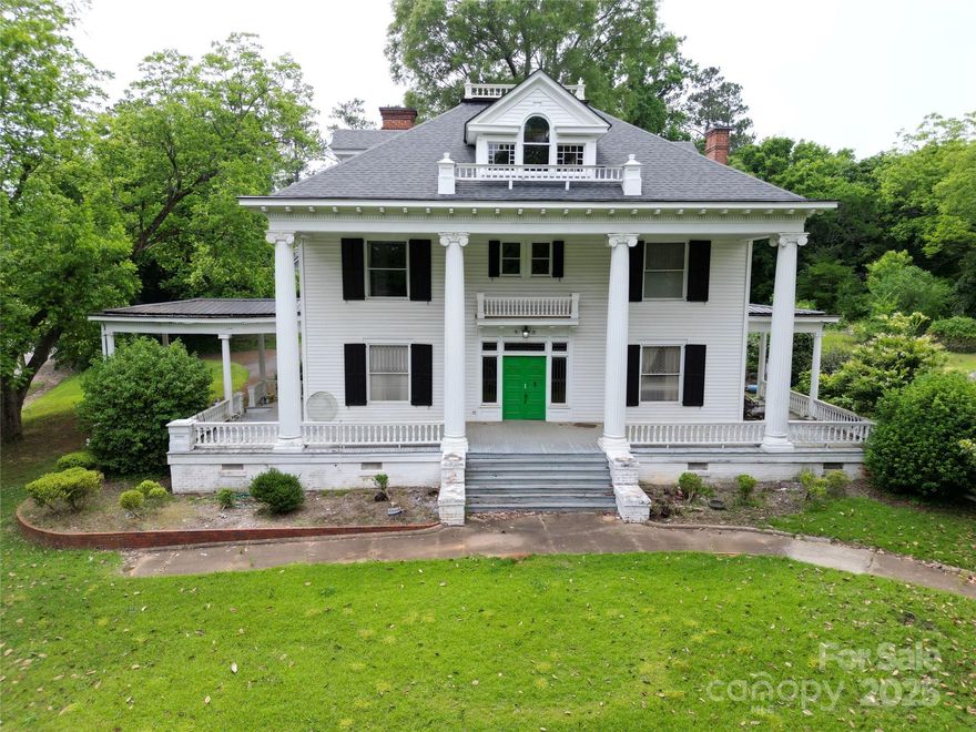 RARE OPPORTUNITY TO OWN A BEAUTIFULLY PRESERVED COLONIAL HOME ON A SPACIOUS 1+ ACRE CORNER LOT IN WADESBORO, NC. Known as the Rose Home, this historic residence offers over 4,000 square feet with 4 bedrooms and 4.5 baths. The home showcases exceptional craftsmanship, including original hardwood floors, high ceilings, spacious rooms, a grand staircase, and stunning woodwork. Recent updates include a newer roof, updated wiring, and a main-level HVAC system, blending modern comfort with timeless character. The updated kitchen includes all appliances. Enjoy flexible living with primary bedroom and bath options on both the main and upper floors. The beautifully landscaped yard features a garden area bordered by limestone, perfect for relaxing or entertaining. Perfect for buyers who appreciate historic charm and are seeking a home they can thoughtfully update over time, this unique property is truly one of a kind.