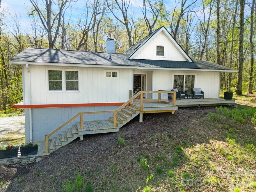 This beautifully remodeled mid-century retreat is hidden just beyond the multimillion-dollar restoration of Rainbow Lake.  Think of floor to ceiling windows bathing the main floor in natural light, eco friendly engineered bamboo floors and a wood burning stove warming the winter (serviced in Feb 2026). All three bathrooms and four bedrooms, including the master ensuite, have been remodeled. Maybe you can turn one room into your office? Did you see the freestanding claw foot bathtub?  New kitchen and appliances.  Every window has been replaced with Pella (even the front door).  

For your toys or hobbies you won't find better space:  a 30' x 40'  free standing pole barn, with light and power. Plus, a downstairs garage and hobby room, insulated and wired to support everything from an electric vehicle to a welding machine. 

Updates in the last 5 years include a new dual fuel furnace and upstairs mini split. New roof in 2021. All new ceiling fans with remote controls. 6 inch gutters and downspouts, LED lighting and Lutron smart lights that are controllable from phone, new kitchen appliances, electrical upgraded to 220 volts in both garage and carport, ultra wide entry steps with large decks in front and back of house.

Start your day with coffee on the back deck, see the sun filter its way through the forest trees. After work, sit on the front porch and watch the orange sunsets. Finish your evening on the screen porch and enjoy the gentle breeze.