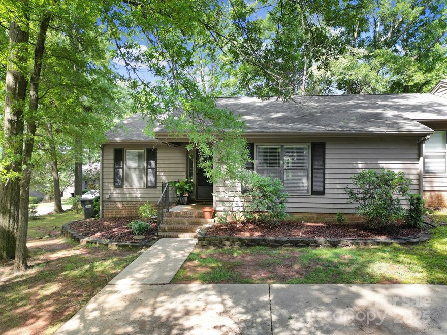 Welcome to Dogwood Hills, a condo complex tucked into a quiet pocket of Regent Park that feels more like a woodsy retreat than a neighborhood. This home offers easy living with an HOA that handles most of the heavy lifting—exterior maintenance, roof, lawn care, termite protection and garbage service so you can spend less time on chores and more time enjoying where you live. Brand new paint freshens up the entire interior, Luxury Vinyl Plank flooring throughout the living space offers easy cleaning, and two full bathrooms for convenience. Notice the beautiful stone faced, wood burning fireplace as the focal point in the living room. Step out of the french doors into the heated and cooled sunroom for additional living space and right on out to the paver patio perfect for grilling and entertaining outside. Close to Fort Mill schools, restaurants, and retail and easy access to I-77 for a Charlotte commute. Take advantage of low SC taxes while working in NC! Don't let this one get away.