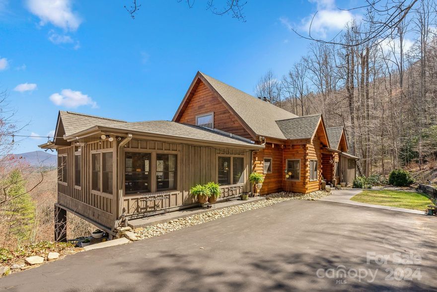 Stunning views!  This mountain oasis boasts a spacious home, guest cabin, babbling stream, extensive landscaping, and a private setting on 16 beautiful acres.  This tastefully renovated home offers an open floorplan, impressive great room, large den, multiple dining areas, loft, 3 bedrooms, 3.5 baths, generous deck, & views.  The primary bath includes a soaking tub, walk-in shower, radiant floor heating, his & her closets, & laundry room.  Additional features include an exercise room, ample storage space, 2-car garage, & workshop with a woodstove.  The furnished, 1BR/1.5bath+loft cabin also has beautiful views and is a perfect space for guests, home office, or an art studio.  So much outdoor space to enjoy, with two fire-pit areas, vegetable garden, garden shed, magical play area, rock outcroppings, & meandering stream. Conveniently located, only 15 minutes to downtown Asheville.