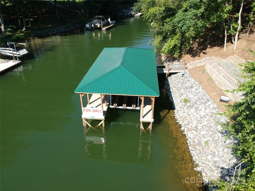 Oversized estate lot on the shores of Lake Norman!  This large 1.64 acre lot is a rare find on Lake Norman and offers an exceptional sized building envelope that can accommodate a large custom home/garage footprint. 5,000 FT / 4 car garage Houseplans are included. Over 200' of shoreline and road frontage, and this rectangular shaped lot is over 350' deep. It is surrounded by high end homes and is halfway down a dead end quiet street. There is an exquisite oversized dock already installed so you can enjoy the water while you build. The overall dock dimensions are 43' by 22' that not only leaves vast entertainment spaces but also a 11' X 32" boatslip.8000 lb Neptune cable boatlift is already installed. The shoreline has been stabilized with rip rap granite rock and there is a keystone retaining wall. The golf cart path provides a convenient path to the dock and shoreline with room to turn around. Come see this waterfront lot located in Hawkes Bay on the northern quiet side of the lake!