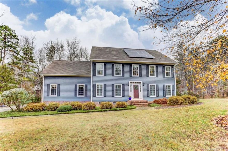 Beautiful traditional home on a wooded lot with solar panels. Bright natural light from large windows and skylights fills the home. Kitchen features granite counters, island and tons of cabinets.  Office with built-ins.  Large master suite with spacious master bathroom featuring granite countertop, his and her sink, garden tub with sep shower. Large deck with hot tub. Detached garage.