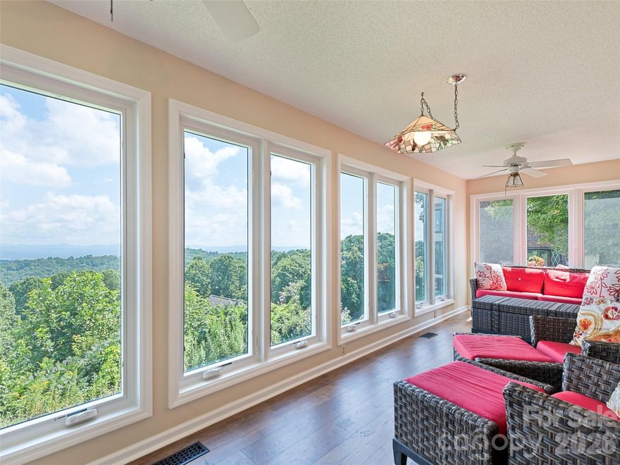 Peace and tranquility from 180-degree breathtaking mountain views every day! This sought-after ground level Laurel Park condo is perched at a little over 3100' just down the street from the scenic overlook of Jump-Off Rock. An expansive living and dining space opens to a relaxing sunroom and balcony keeping breathtaking mountains in constant view even from the primary bedroom. Kitchen features functional cabinetry with a built-in pull-out desk and under cabinet lighting. On the lower level are two generously sized bonus rooms ideal for 3rd bedroom, office space or pursuing your hobbies with added built-in desk areas and a huge storage room/work area. A back patio on the ground level is a great spot to savor the views from an additional sanctuary.