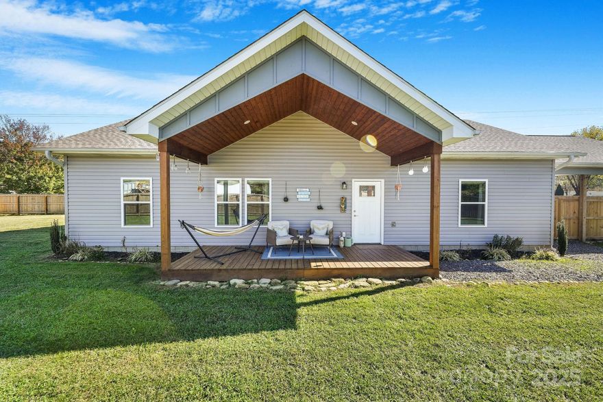 Priced out of Asheville? Welcome to Waynesville! Built in 2022, this 3-bedroom, 2-bath home is fresh, fun, and completely move-in ready. Step inside to soaring vaulted ceilings and an airy, open layout that makes everything feel light and easy. The kitchen comes stocked with sleek stainless steel appliances and an island, while the primary suite delivers serious "wow-factor!" with the oversized walk-in closet and a spa-like tiled shower. Can convey with furniture - just ask! Know what else you'll love about Waynesville and this home? The incredibly affordable property taxes!

But let’s be real—the yard steals the show. Over half an acre, completely flat, fully fenced, and begging for barbecues, soccer games, or a four-legged friend or two. From the big front porch (yes, with its own dramatic vaulted ceiling), you’ll enjoy mountain views in every direction.

And location? Spot on. Just 2.5 miles to Blue Ghost Coffee, 10 min to Main Street Waynesville, 10 min to Maggie Valley, and minutes from Lake Junaluska, Western Carolina University, and outdoor adventures galore.

Big yard, big porch, big views—it’s all here, waiting for you.