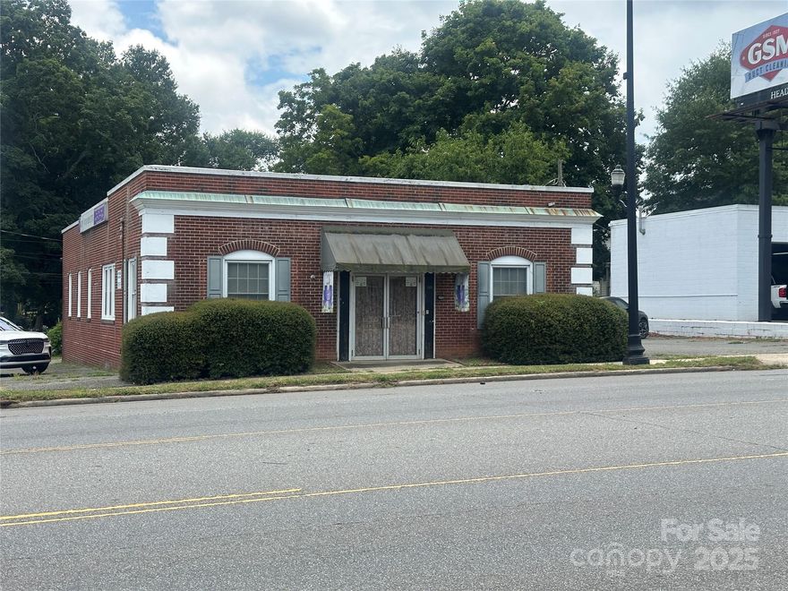 Take advantage of this rare opportunity to own a freestanding commercial property just steps away from Gastonia's revitalized  FUSE district - a fast growing  hub for business, sports, dining and entertainment. This high-visibility corner property is ideally situated on W. Franklin Blvd. with excellent street frontage, high foot traffic, open floor plan with 3 small offices, two restrooms and small kitchen area.  Adaptable for retail, office, creative space, brewery/taproom, medical or flex use.On site parking and street parking.  Possibilities are wide open.