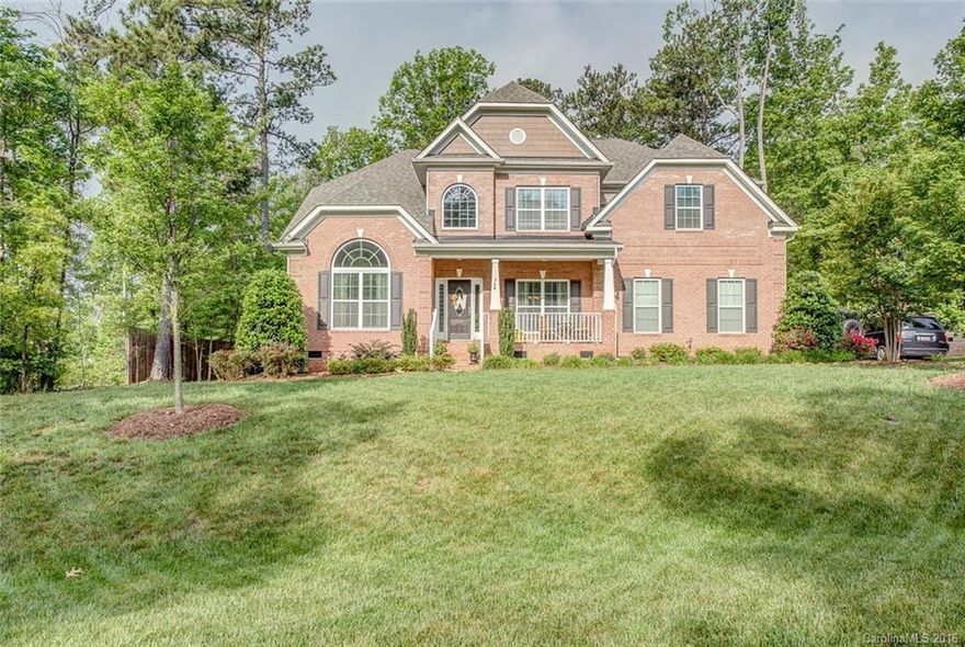 Heron Cove S/D.  Clover School District. Gorgeous 5 bedroom French Provincial brick home (master on main).  Home features impressive foyer, arched windows, coffered ceilings, recessed lighting, wood flooring, gourmet kitchen (w/ SS appliances, granite, bar, center island) large rec room, loft, attic pull down, side-load garage (with lots of storage space), gutter guard,  deck overlooking wooded back yard, irrigation (front & back), established landscaping, steps from community pool.