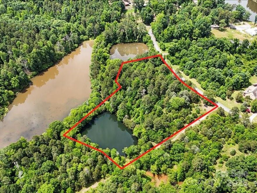 Incredible opportunity to own 4.66 acres  in the peaceful countryside of Cabarrus County! This rare gem is located along the scenic Lake Lynn, offering natural beauty, privacy, and the perfect backdrop for your dream home or mini farm. With gently rolling terrain and direct water frontage, you’ll enjoy tranquil views, potential for fishing or small boating, and the peaceful sounds of nature—all just minutes from Concord’s amenities.
