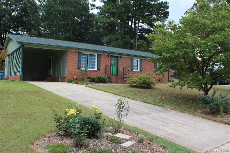 MUCH larger than it appears. Four good-sized bedrooms and three baths. Kitchen with island and breakfast area.  Living room, family room, master suite has walk-in closet and private bath with his & her showers!  Lots of storage - linen closet, coat closet, and storage closet.  Screened in porch, gorgeous landscaping with fenced back yard.  Storage room off carport.  Hardwoods, newer roof, alarm system.  Loved and maintained by current owners.