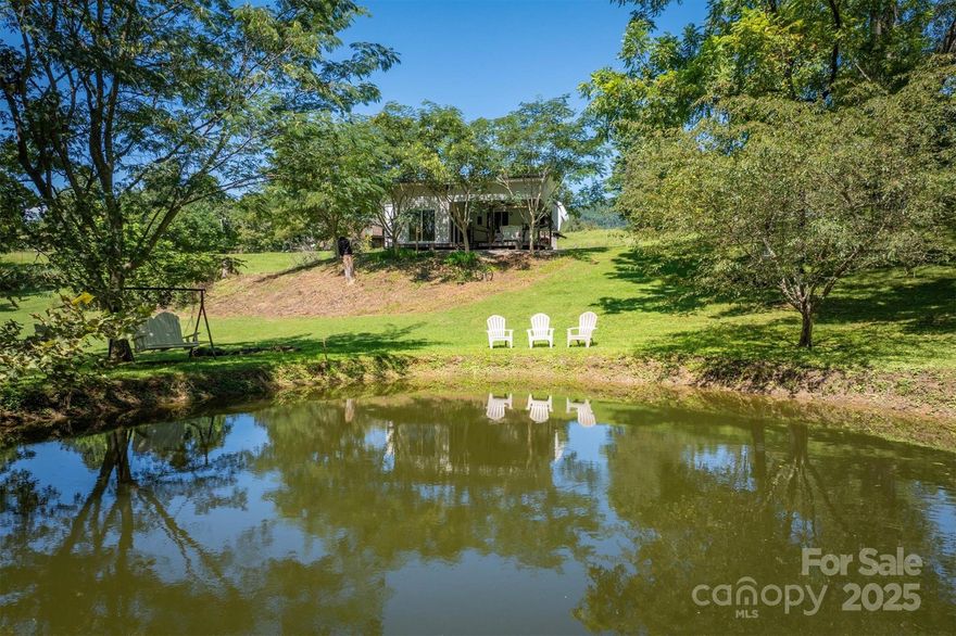 Unique opportunity on approximately 2 acres with a stocked fish pond and full utility hookups in place. A covered deck with an attached climate-controlled, wired storage room overlooks the pond, offering the perfect space to relax or entertain. Parked beside the deck is a 2010 35-ft Forest River Sandpiper Loft fifth-wheel camper, featuring fully functional slide-outs, plumbing, electrical, HVAC, and appliances. Behind the camper is a storage shed with a John Deere riding mower that conveys with the property. Power and water are already connected, and the property previously supported a single-wide, providing additional flexibility for future use. Whether as a weekend retreat, investment, or future homesite, this property delivers a rare blend of privacy, convenience, and outdoor enjoyment. Has a shared well.