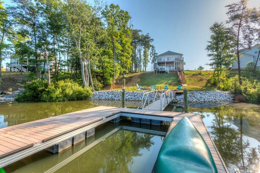 Waterfront, Golf Course community with pool, cabana, tennis courts, waterside pavilion, marina, trails and more just 30 minutes from Rock Hill and Waxhaw, 45 minutes from Charlotte and an Hour to Columbia. This adorable 3 bedroom, 2 bath bungalow sits on a double lot with expansive views.  Finished basement with a HUGE game/rec room as well as an enclosed room that is currently used as a 4th bedroom. There is a full bath on the lower level as well as a screen porch and covered deck.