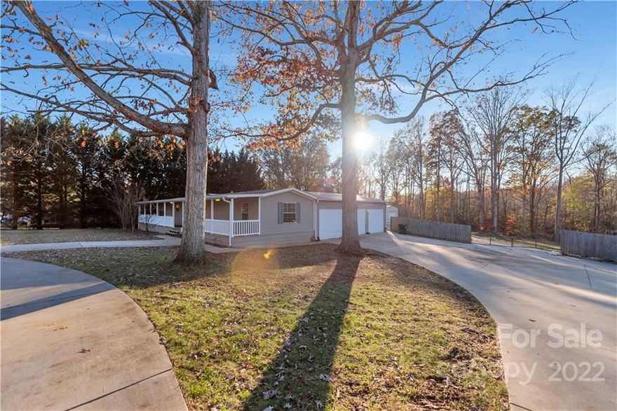 Over an acre and a half of space for your RV, boat, or other toys.  Spread out with a massive three bay insulated & attached garage AND a separate 3 bay detached workshop or garage space with 25k lb lift available for purchase.  Multiple covered concrete parking pads.  Full front porch is covered.  Owner's suite was added and offers upgrades and storage space.  No HOA or City Taxes.  Minutes from Lake Wylie and public boat launch.  Situated on double lot in rural setting but with easy access to everything!  Workshop area has its own half bath, air compressor, & HVAC. The private owner’s suite was added to include double walk-in closets, jetted tub and walk-in shower, and your conveniently located laundry with sink is attached to the owner’s bath. Need more extras? Circular drive and then some, rocking chair front porch along the full front façade, pecan tree on property, two Champion room additions for your relaxed lifestyle…  Come see it for yourself!
