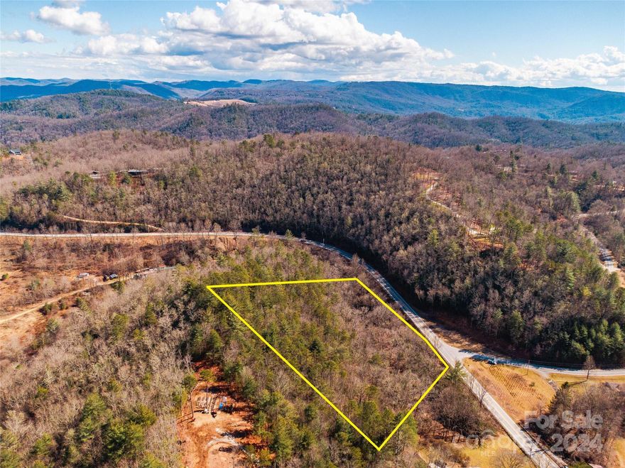 This 7+ acre unzoned parcel is brimming with possibility.  With only about 200' of elevation change and frontage on Highway 64W, it has both commercial and residential appeal.  The best building site is tucked amongst the trees away from the bustle of 64 and has mountain views.  There is also a bold stream along the front of the property.  If you have dreamt of creating a business close to home, this may the site for you.