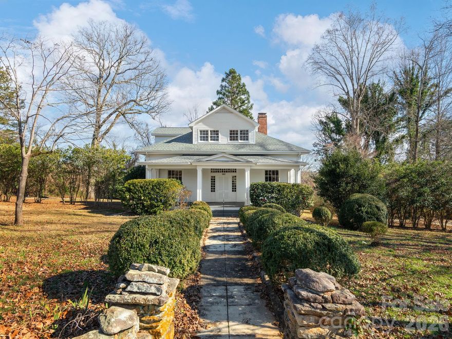 Stately Charm Meets Modern Luxury! Experience the perfect blend of historic character and modern sophistication in the heart of Rutherfordton. This beautifully renovated home features soaring ceilings, exquisite dental molding, and original refinished hardwoods (2024), all within less than half a mile of downtown shops and the hospital. The main level includes a spacious study anchored by a rustic fireplace with exposed wood beams, and living and dining rooms featuring elegant chandeliers. The chef’s kitchen has been fully updated with a suite of new stainless steel appliances, while the primary bedroom on the main floor offers a luxurious ensuite bathroom. With a new roof (2024) and updated flooring throughout, this turn-key home combines character, comfort, and modern convenience. Enjoy the mature, lush landscaping from your yard, or take advantage of the nearby Thermal Belt Rail Trail for recreation. The exterior siding is cedar wood siding. All appliances, including the washer/dryer, are included, and the property is conveniently located approximately 20 minutes (27 miles) from the  Tryon International Equestrian Center. Back sunroom is a bonus space in need of repairs; code compliance unverified. Home is sold as-is.