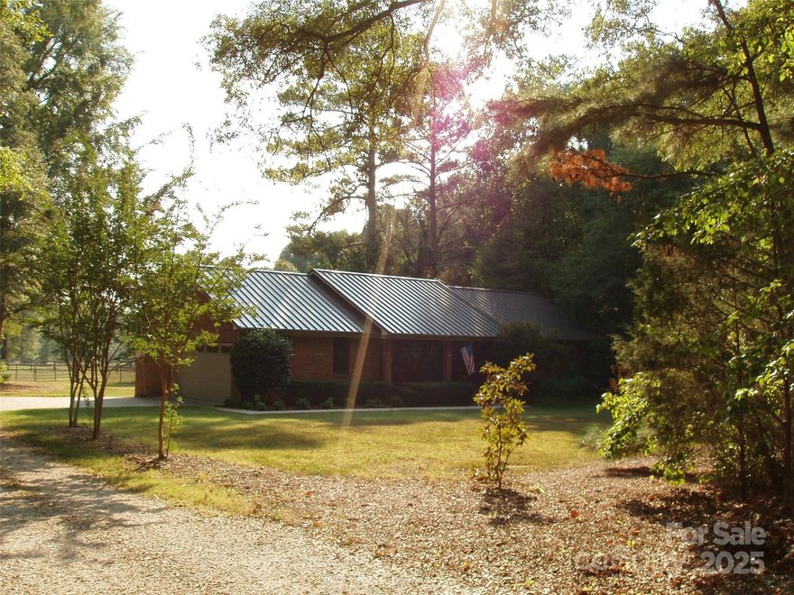 Beautiful brick home in excellent condition on 20 +/- acres mainly pasture with a shared pond and fencing in place.
Three bedroom two full bath home with two car attached garage.  Covered pavilion with firepit, fenced back yard and fencing around most of the pasture area. Two bay run-in shed for horses or livestock. Rural setting in York County Located southwest of Rock Hill approximately 7.5 miles from Piedmont Medical Hospital and 11.6 miles to I-77 & Hwy. 21 / Cherry Rd exit.