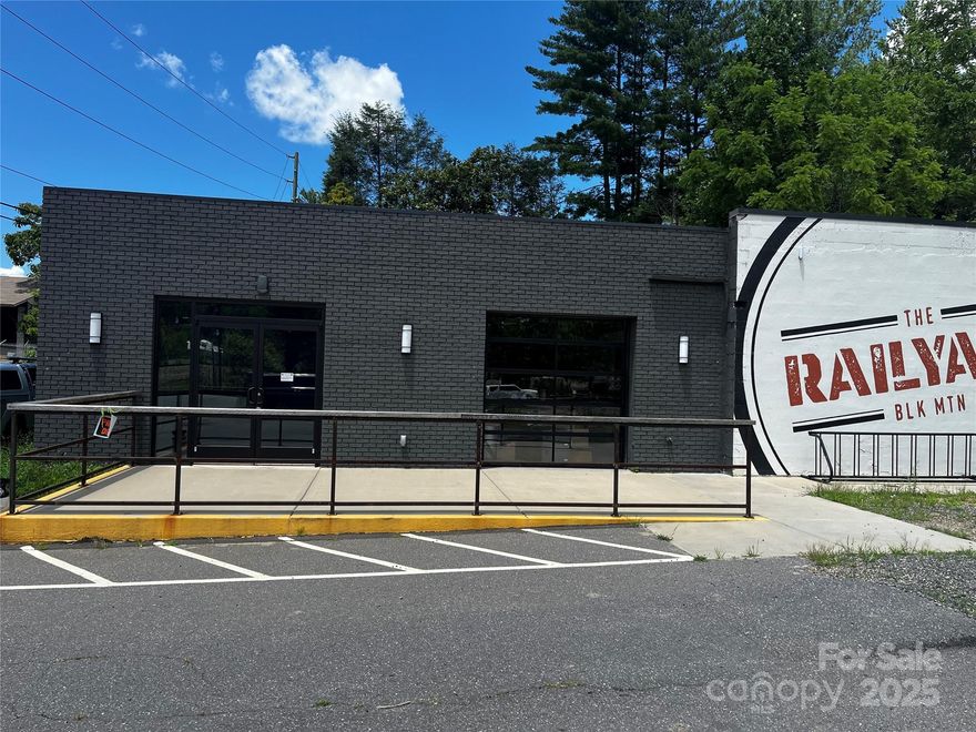 Price Just Reduced:  Fully furnished Restaurant/Bar in Black Mountain.  Open floor plan.  Roll-up doors.  Small outside stage area.  1.09/ac site could be redeveloped.  Approx. 6,600/sf building.  Long Bar.  2 commercial kitchens with hoods & equipment. Includes all FF&E.  Lot runs from S. Richardson to S. Ridgeway.  Property is called the Rail Yard.