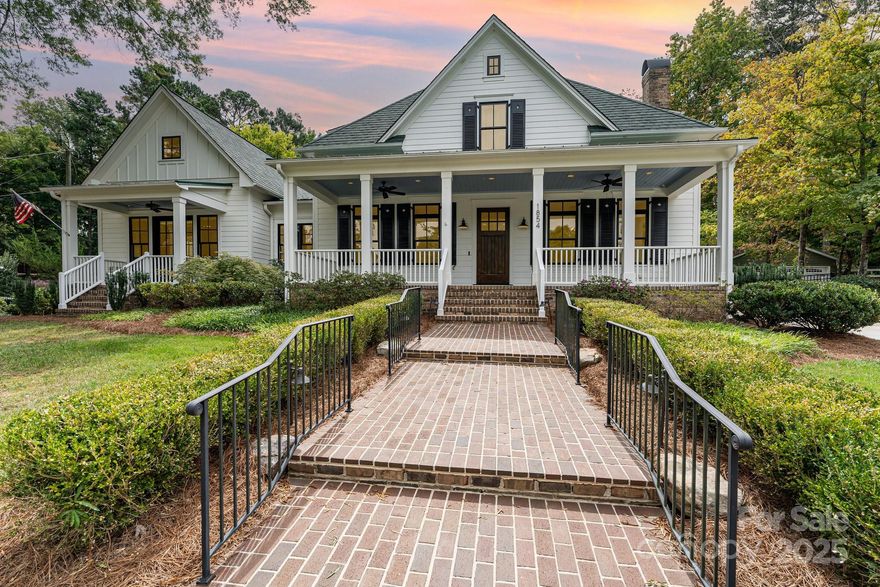 Custom-built in 2017, this single-owner Buena Vista home blends timeless design with livability. The main level offers two suites: the front primary with sitting area, powder room, dual vanities, two walk-in closets, porch access, and laundry; and a rear suite with walk-in shower, tub, and nearby laundry. Upstairs has a third en suite, Upstairs open area with full bath-easily convertible to an additional bedroom, and cedar storage. The kitchen features premium finishes, butler’s pantry, and morning bar with Sub-Zero drawers, opening to dining and family spaces. The living room offers built-ins, gas fireplace, and cocktail alcove, while walnut hardwoods extend throughout. The family room opens to a courtyard with stone waterfall. A gated drive leads to a four-car garage with finished suite, full bath, and expansion space. The carriage house adds kitchenette, half bath, epoxy floors, and storage—ideal for workshop, studio, or guest retreat. Outdoor living includes a circle drive, dual covered porches, screened porch with fireplace, and courtyard.