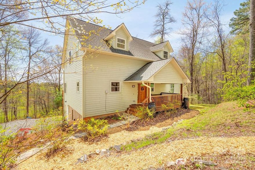 Beautiful mountain home in Marshall, with quick access to Mars Hill, Weaverville, and Asheville! 3 bedrooms, 3.5 baths, and over 2,200sf—plus 1,293sf of additional basement/garage space. Enjoy high-speed fiber optic internet, a tankless water heater, and a private well. The main-level primary suite includes a walk-in closet, tiled shower, and whirlpool tub. Outdoor spaces shine with a wrap-around deck, covered porches, low-maintenance landscaping (including blueberry bushes), and a fire pit area. Inside, you'll love the natural light, ample storage, and semi-finished basement bonus space—ideal for a gym, office, studio, or workshop, with potential to finish for more square footage. Additional perks include an attached 1-car garage, winter mountain views, and access to a peaceful community pond and trail. Located in the Chestnut Hill community, low-cost HOA dues paid through 2025. Move-in ready and perfectly blends modern comfort with serene mountain living!