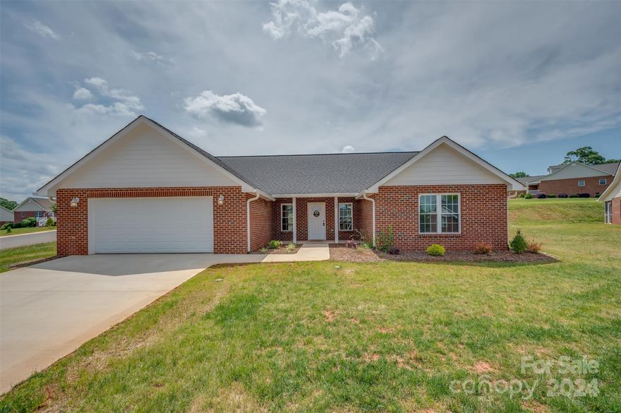 Beautiful new construction home located in Sparks Crossing, a well-established 55+ community. This 2-bedroom, 2 full bath floorplan is open concept and has wide doorways, vaulted ceilings, a beautiful gas log fireplace, granite countertops, and soft close cabinets/drawers. The 2-car garage and walk in closets are oversized and offer ample space for extra storage, if needed. Last but not least, a relaxing screened porch on the back of the home is the perfect spot to enjoy the outdoors after a long day. Sparks Crossing is a 55+ community with an HOA that maintains the landscaping. It also provides two stocked ponds, underground utilities, public water and sewer, and has very easy access to the Thermal Belt Rail Trail. Don't miss the opportunity to call Sparks Crossing your home!