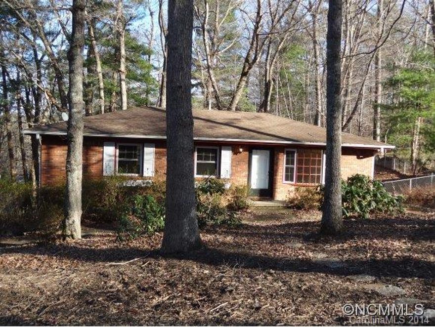 Well maintained home in well established, convenient neighborhood less than 10 minutes East of Downtown Asheville. Hardwood floors, large bay window in living room, rear deck overlooks private, wooded and fenced back yard. Beautiful mature trees. Full drive-in basement features plenty of workshop space. Lots of home, yard and location for the price.