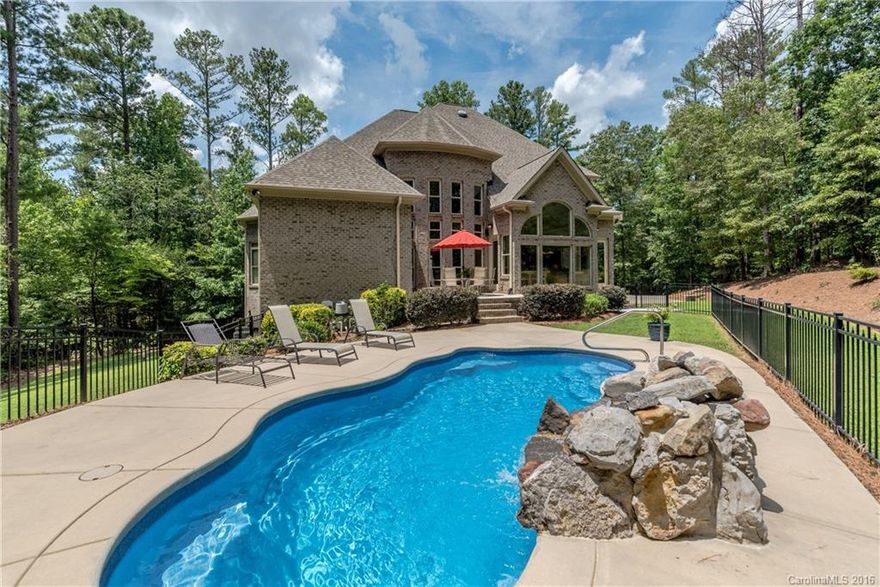 Custom built brick home on private cul-de-sac wooded lot.  Stone & hardwood flooring, crown molding. Gourmet kitchen custom cabinetry & granite, large island w/prep sink, breakfast area/sunroom. Master on main with tray ceiling.  Master bath separate granite vanities, large walk-in stone shower. Open foyer & vaulted Great Room, 3 fireplaces. Upstairs 3 bedrooms, 2 full baths including Jack n Jill bath, large bonus room plus exercise/playroom room. Side 3 Car Garage, Saltwater Pool. Central Vac.