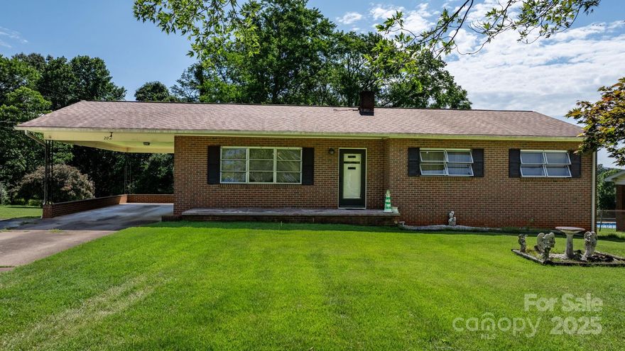 Lots of potential with this vintage, brick ranch that was well built in 1965. New heat pump being installed and old boiler in basement to be removed. Situated on two lots totaling .85 acre close to downtown Morganton this home is in need of some tlc.  It features 3 bedrooms, 2 baths, spacious living room with large windows, open kitchen and dining area with fridge, newer cooktop and wall oven.  Home has hardwood, tile, vinyl and carpet flooring, an attic fan.  Unfinished basement provides ample space for storage, laundry and basement garage.  Front wall of basement has some seepage in heavy rain. Views of the mountains from the lovely back yard, perfect for all outdoor activities or relaxation. Convenient to I-40, downtown Morganton and all necessities. Estate being sold "AS IS".