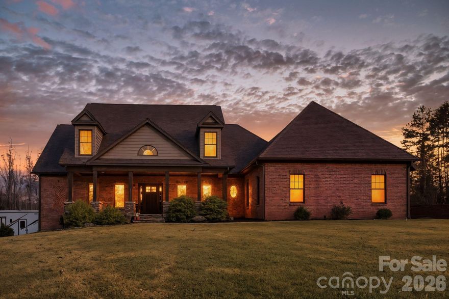 Welcome to 476 Ijames (pronounced imes, like chimes) Church Road, a beautifully designed custom-built home nestled on ±5 acres of wooded and open land, carved from a larger 50+ acre estate. This home offers over 2,400 sq. ft. of finished living space and a total area of 6,858 sq. ft. across three levels.

Set well off the road, this distinguished all-brick home welcomes you with a long, private driveway, and immediately a sense of tranquility unfolds. As you arrive, the front porch welcomes you, anchored by real stone column bases and matching stone steps that speak to timeless craftsmanship and enduring quality. The genuine hand-laid stone, offer natural texture, depth, and character that elevate the home's architectural presence.

From the moment you enter, chamfered corner walls, beautiful inlaid hardwoods, and custom millwork set a gracious tone. The inviting great room features tray ceilings, a gas fireplace, and large windows that frame sweeping countryside views, creating a warm, light-filled heart of the home. The kitchen is thoughtfully designed, perfect for daily living and effortless entertaining. The main-level primary suite is a true retreat, offering a spacious walk-in closet, a spa-like bath with double vanities, soaking tub, and separate shower. Two generously sized guest bedrooms, a dedicated office, dining room and breakfast nook ensure comfort and privacy for family and guests alike.

The third floor boasts an additional 1,307 sq ft of unfinished, unheated space just waiting for your vision. Whether you're dreaming of a home theater, gym, guest suite, or additional gathering room, this bonus area offers incredible flexibility and future equity.

Step downstairs into over 2,400 sq. ft. of untapped potential - a blank canvas ready to become the ultimate extension of your home. This expansive unfinished basement is built with durable poured concrete walls and is equipped with plumbing for a future bathroom and kitchen, giving you the freedom to design a custom suite, entertainment hub, or private retreat. A cozy wood-burning fireplace adds character and warmth, setting the stage for endless possibilities.

The oversized garage flows seamlessly to a dedicated concrete pad, thoughtfully designed for RV enthusiasts with full hookup and clean-out included. Whether you envision a guest apartment, entertainment hub, or the perfect getaway for family and friends, the basement offers unlimited potential, all within the comfort of home.
Every detail of this home has been thoughtfully curated to blend comfort, sophistication, and endless possibilities.