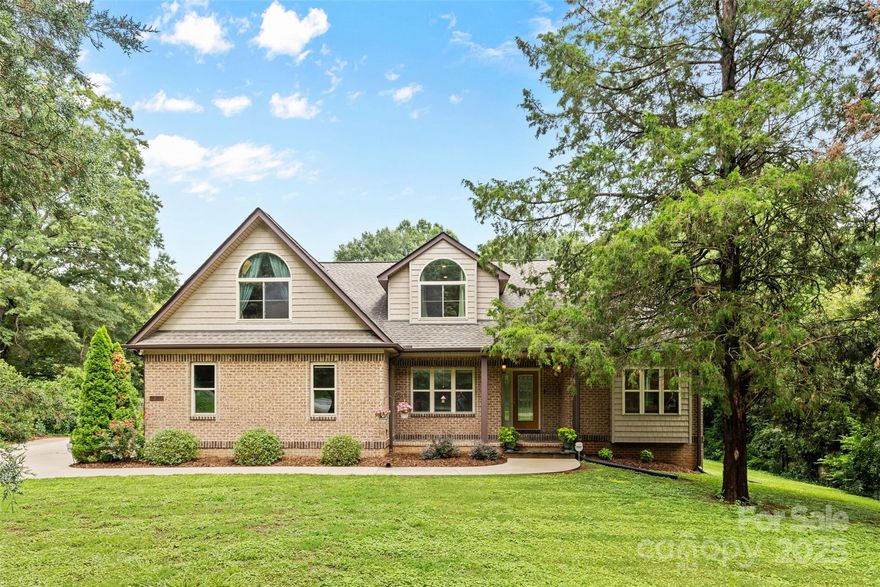 Exquisite brick-front residence in the heart of Mint Hill—NO HOA! Nestled on a private lot with an oversized driveway and side-load garage! This 3 bedroom +bonus room home greets you with a dramatic foyer and sun-filled 2 story living room overlooking the lush backyard. The gourmet kitchen offers white cabinetry, new dishwasher and cooktop, abundant counters, a movable island, and generous storage. The main-level primary suite boasts a spa-like bath and spacious walk-in closet. Upstairs features two large bedrooms, oversized closets, a grand bonus room, and walk-in attic storage. Tankless gas water heather. The unfinished basement with French doors to the backyard offers endless possibilities—workshop, gym, or future living space. Relax or entertain on the expansive covered deck, perfect for morning coffee or evening gatherings in your serene backyard oasis.