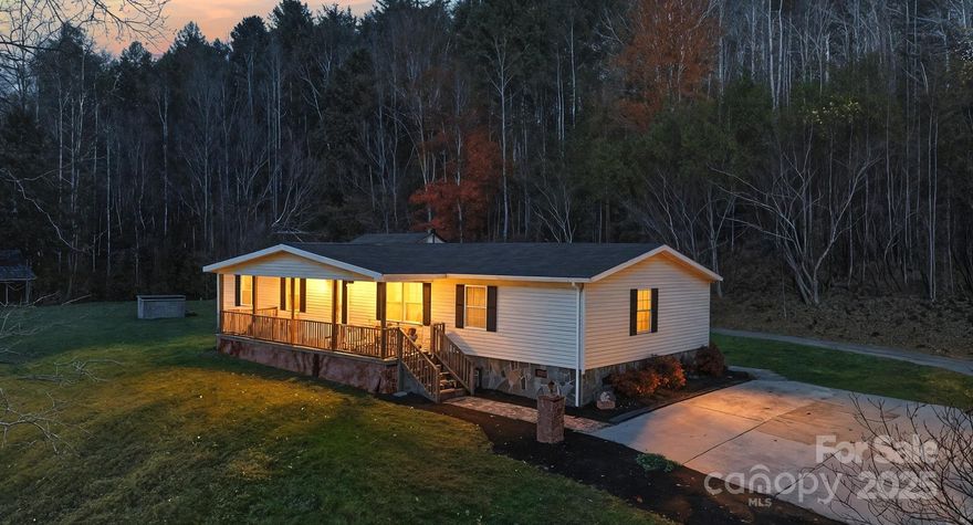 Escape to your own private mountain retreat on +/- 30 secluded acres at the end of a quiet country road. This beautiful 3-bed, 2-bath home welcomes you with a covered front porch, a spacious back deck, and plenty of outdoor living space to take in the peace of the foothills. Inside, the home is bright, inviting, and move-in ready—perfect as a full-time residence or weekend escape. A two-bay detached garage with an upper level provides excellent storage, a workshop area, or future guest space. The property features old logging roads and a bold creek running along one side of the property line. A flat old homeplace offers the ideal setting for a new build site or garden area. With no HOA and no restrictions, you’re free to live, ride, hunt, or simply unwind surrounded by nature. Whether you’re looking for a private homestead, a family compound, or a place to play in the North Carolina mountains, 3066 Hartley Kincaid Road delivers room to roam and a lifestyle that’s hard to find.