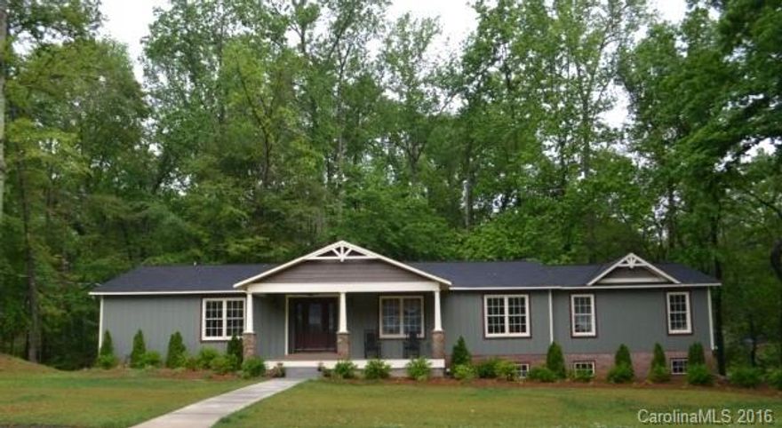 Nature is calling! Listen to the natural water feature from this backyard! This beautiful ranch is fully updated and sits on 1.42 acres.  All living on main level plus a finished basement downstairs.  Open layout! 4 bedrooms, 4 full baths, dining room, great room with gas logs and spacious kitchen with granite counters and stainless appliances.  Rocking chair front porch and a deck with beautiful wooded view of the creek.  Fantastic location, near restaurants and shops.  Will not last long!