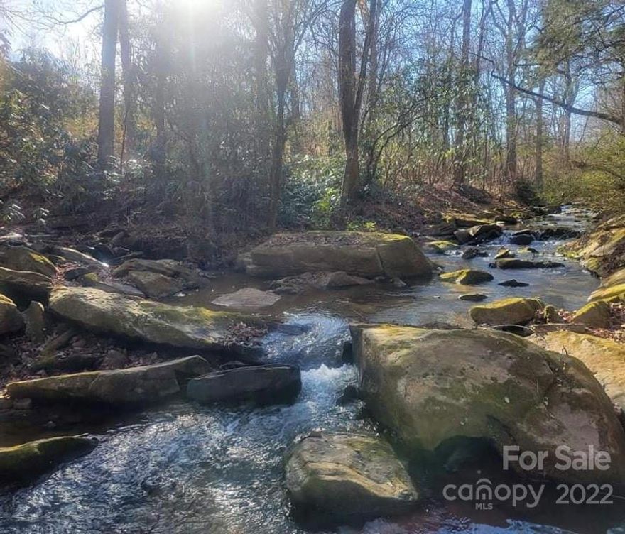 This beautiful lot is perfectly located in the country, but it is within a 30-minute drive to Hickory and Morganton.  The property has a working well and septic for up to a 3 bed, 2 bath house.  Property has electric as well.  This property is a must see with a beautiful creek that runs alongside it.