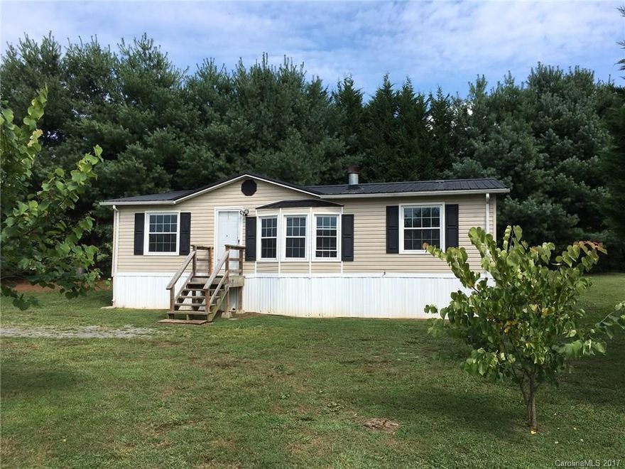 Nice home located on .37 acres with mid to long range views from the front door.  This home has fresh paint, new laminate wood floors, central air heat pump less than two years old, metal roof less than two years old.  Nice yard bordered with tall pine trees.  A wood burning fireplace in the family room.  Three bedrooms and two baths.