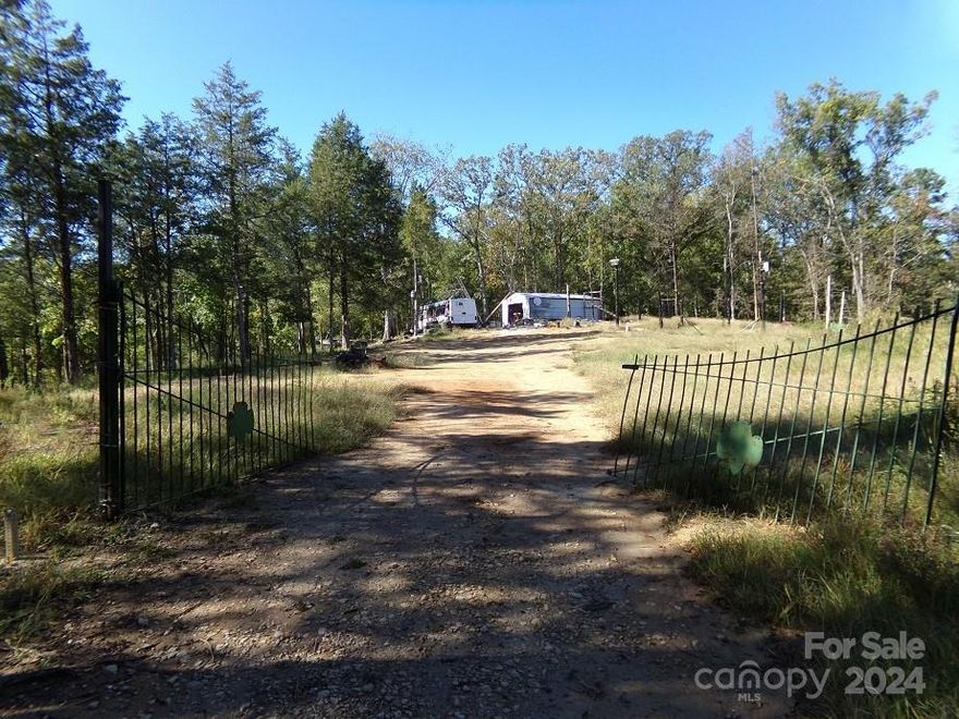 Ideal 10.3 acre parcel in McConnells SC area of York County.  Two homesites have been cleared out on opposite ends of the land on nice hilltops.  A gravel driveway goes into the west side.  A metal shop is located on the east side.  Good internal access is ideal for ATVs, dirt bikes or walking trails.  There is a nice sized garden spot cleared where the soil changes to brown farm soils.  This tract has pockets of hardwoods and cedars, but it predominantly young pines.  The pines offer bedding cover for white tail deer.  RV and minor debris on property will be removed.