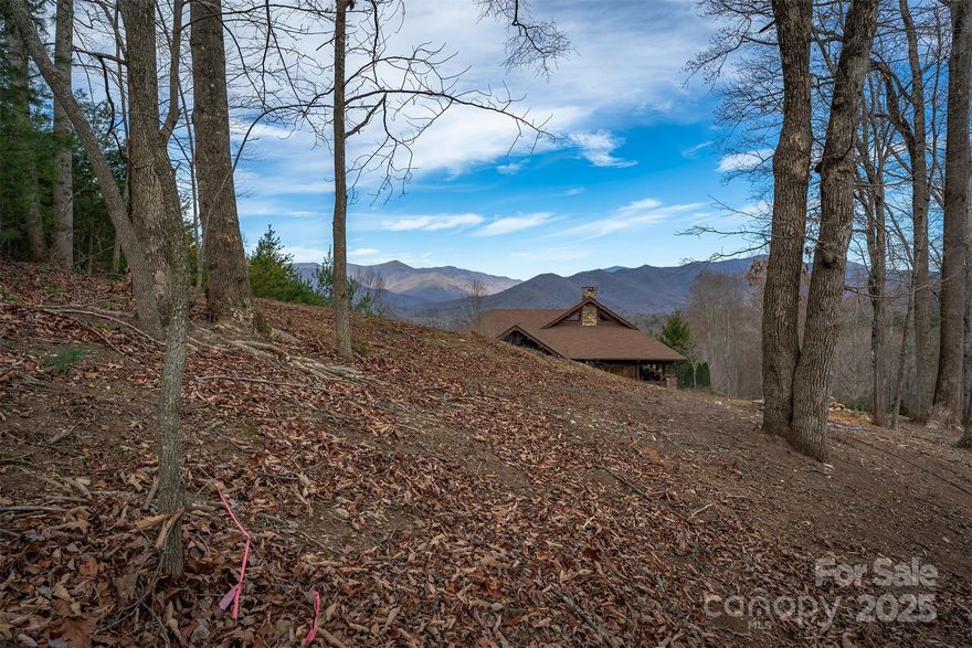 Build your dream home on 31 Old Lafayette Lane, a premier "Cottage" homesite (see attached Plat, Lot 22) located within The Settings of Black Mountain. This .21ac+/- lot offers a rare combination of convenience and high-altitude beauty, featuring landscape mostly cleared that transitions at its uppermost portion (max elev @2,635') into a breathtaking north/northwesterly long-range vista. Enjoy a sweeping view of the upper Swannanoa Valley framed by the majestic peaks of the Black Mountain Range. The lot features an average slope of only 24.42%, providing an ideal canvas for a custom build that maximizes the mountain scenery. Situated within the "CR-1" zoning district, the property benefits from Town of Black Mountain maintained roads and infrastructure.
The Settings of Black Mountain (TSoBM)...The Settings is widely regarded as one of Western North Carolina’s most elite communities, attracting top-tier award winning custom builders and discerning buyers seeking a sophisticated mountain lifestyle. While the neighborhood feels like a secluded retreat, it is located just a couple of scenic miles from the heart of downtown Black Mountain. Residents enjoy immediate access to the town’s vibrant shopping, award-winning restaurants, local arts and crafts, and year-round music and entertainment.

Basic Property Details: (please see attached docs to the MLS listing or ask your Broker for them)
Infrastructure: Paved, town-maintained roads, small community park
Views: Long-range northerly views of the Black Mountain Range, most of the highest peaks in eastern America
Explore the area further and verify property details through Buncombe County's GIS website or browse local amenities via the Black Mountain Chamber of Commerce or investigate community people and events through the Valley Echo website.