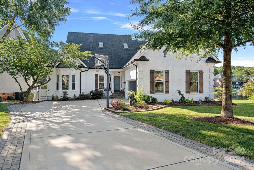 Welcome to your lakefront dream home on Lake Norman! This gorgeous, well-maintained & updated waterfront gem features 5BD/3.5BA/2 car garage all set in white brick w/breathtaking lake views. On the main level enjoy an open floor plan with rich wood floors, new custom kitchen, sunroom, drop zone, laundry room, primary bedroom, 2 secondary bedrooms, 2 full baths. Upper Level includes 2 additional bedrooms, 1 full bath, 1 half bath, loft, office/exercise room, & flex space. Updates include: new roof, new kitchen, updated bathrooms, wood-burning fireplace, back deck, fresh paint, & fire pit. Personal steps lead into the lake for swimming, kayaking, paddle boarding. Community features lakefront pool, tennis/pickleball court, docks, & personal boat slip at community dock just a short walk from your home. HOA covers lawn care, weekly mowing, pool, tennis court, & dock maintenance. Don't miss the opportunity to own this waterfront paradise. Located close to Birkdale, shopping, restaurants.