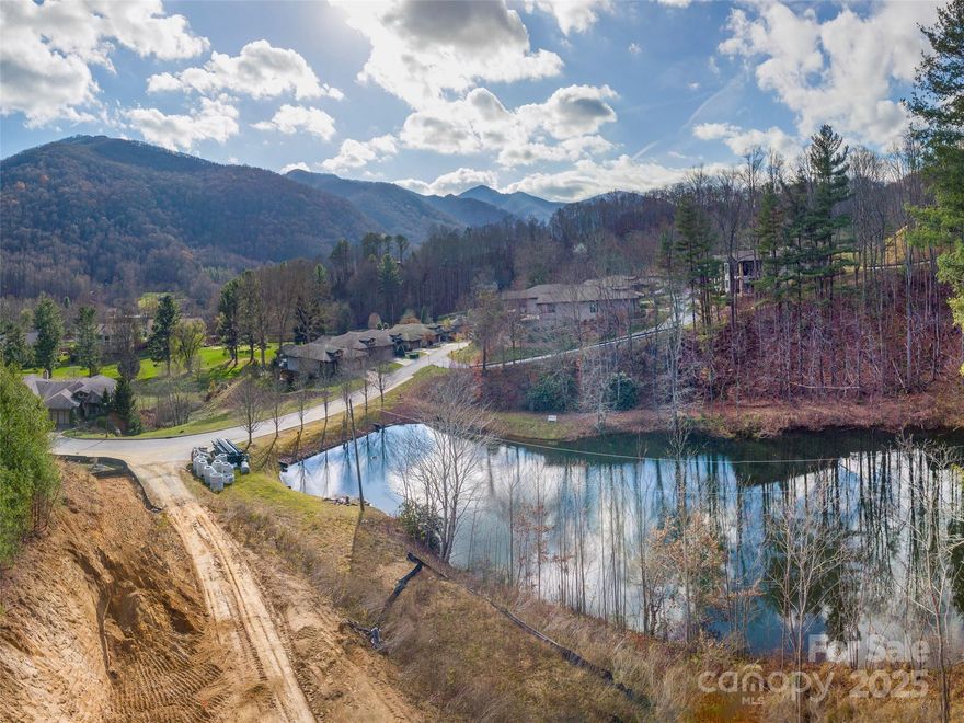 Waterfront lot at The Views at Masters Landing on the topside of Maggie Valley Club & Resort. Choice lots remain, including this one overlooking the pond and mountains to the SW beyond. Design your custom Distinctive Building & Design-built home in a streamlined, enjoyable process. Countless build options for your home, which will be a product of quality materials and precision craftsmanship. Ownership includes MV Club membership and access to its amenities. Great accessibility, city water/sewer, underground utilities, high speed internet.