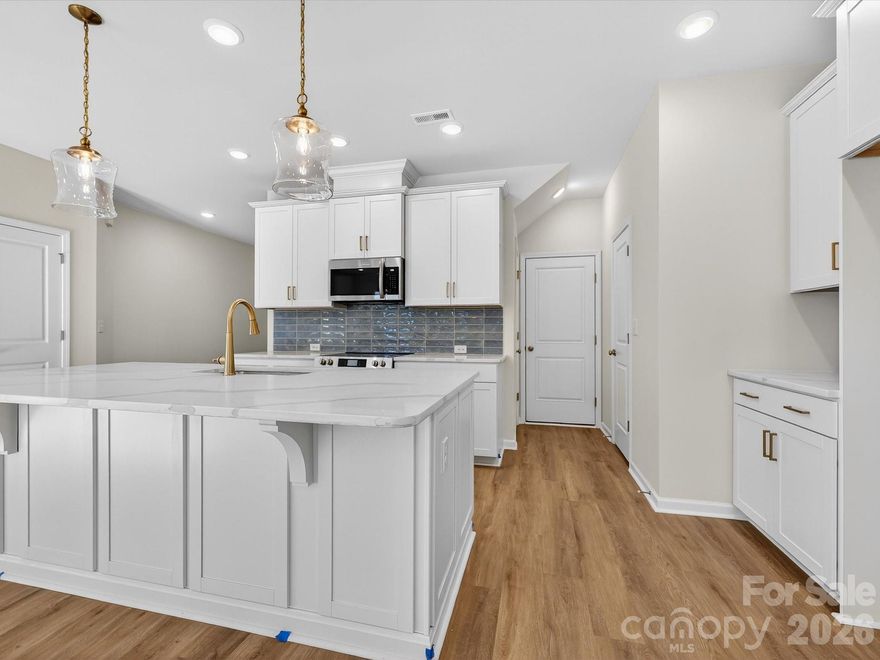 Discover the ease of luxury low-maintenance living in this brand-new Thornhurst II townhome, conveniently located just minutes from Ballantyne, Waverly, and the charming shops and restaurants of historic downtown Waxhaw.
Filled with natural light, the open-concept living area is highlighted by three large picture windows overlooking a private wooded backyard. The designer kitchen features 42” white-colored soft-close cabinetry, sleek quartz countertops, a spacious island open to the family room, Frigidaire stainless steel appliances, an exterior-vented range hood, and a pantry with solid shelving.
The main level showcases durable LVP flooring throughout, along with composite stair treads leading to the second floor. Upstairs, unwind in the luxurious Owner’s Retreat featuring a tray ceiling, oversized walk-in closet, and three large windows that create a bright, airy feel. The spa-inspired primary bath offers tiled flooring, a large tiled walk-in shower with bench seating, dual vanities with quartz countertops and soft-close cabinetry, a linen closet, and a private water closet.
The second floor also includes two spacious secondary bedrooms, a full hall bath, and a thoughtfully designed laundry room with tiled flooring and a convenient folding table.
Enjoy peaceful mornings or relaxing evenings on the covered porch overlooking the wooded backyard. A side-by-side two-car garage and full driveway provide ample parking for both homeowners and guests.
With low taxes, low-maintenance living, and the feel of a single-family home, this townhome offers the perfect blend of comfort, convenience, and style. Ask about special low-interest rate opportunities!