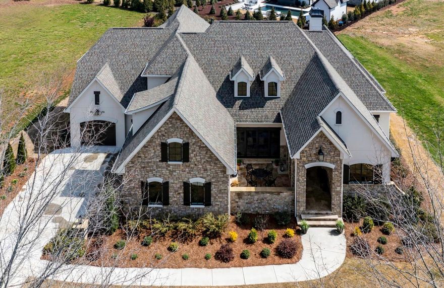 Luxury French manor home built in 2021 in Skyecroft, a gated amenity-rich custom home community south of Charlotte & zoned for top-rated Weddington schools! A private travertine front courtyard opens to entry & formal dining room. Soaring beamed vaulted ceilings, arches, rounded corners, white oak hardwoods, 7.5 in. baseboards & moldings, Eudy's custom cabinetry plus Windsor bronze casement windows & doors are highlights of this exceptional home. Kitchen w/ Thermador appliances has Mont blanc quartzite countertops & an expansive island. Living spaces include a living room w/ cast stone fireplace, a den, & a media room w/ surround sound. A downstairs study w/ custom shelving gives great work space, while both a primary suite & guest suite on the main have large custom closets. The travertine screened porch overlooks a pavestone patio w/ gas grill & the fully fenced landscaped 1/2 acre+ yard. Storage abounds in the garage, the kitchen, extra storage nooks & in walk-in attic spaces!